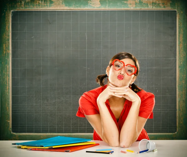 Sensual dreamy young student red dressed with glasses and blackboard