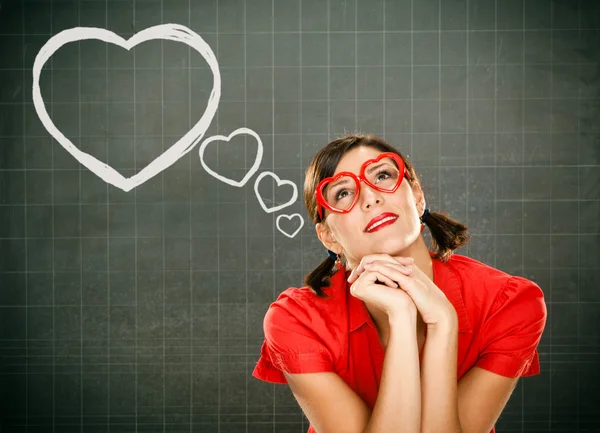 Sensual dreamy young student red dressed with glasses and blackboard