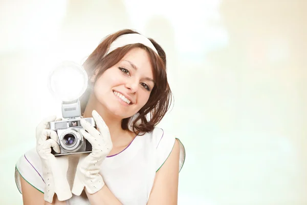 Beautiful vintage girl take photograph with old camera