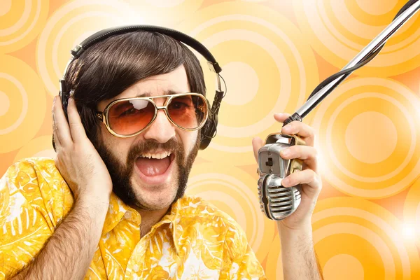 1970s vintage show man sing with hawaiian shirt and microphone on yellow background