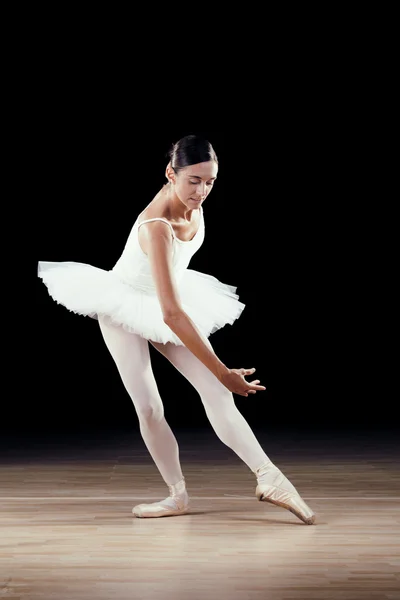 Beautiful classical dancer on black background