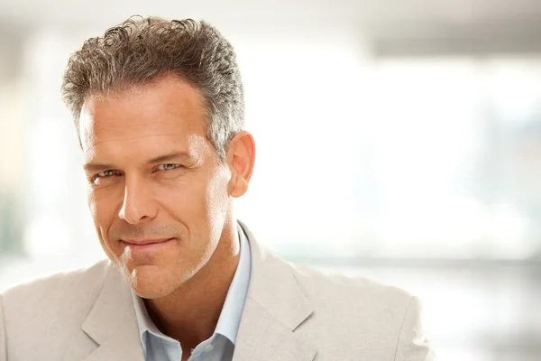 Handsome smiling businessman gaze portrait at office