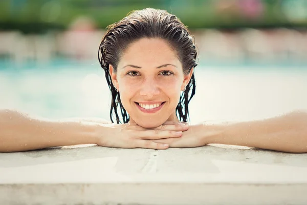 Beautiful girl in bikini at swimming pool outdoor