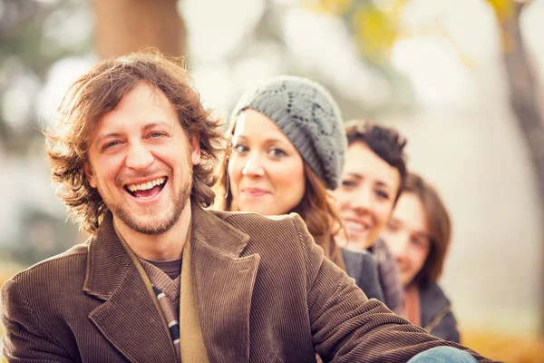 Group of Friends having fun at the park  in autumn