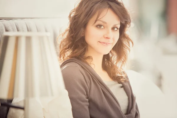 Young smiling brunette girl read in her bedroom