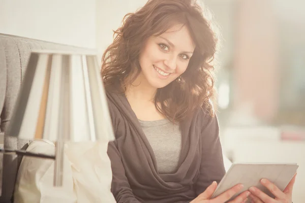 Young smiling brunette girl read in her bedroom