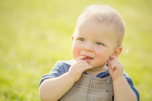 Happy smiling blond child play in the park