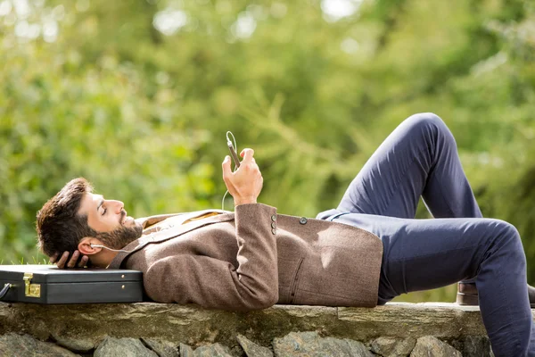 Premium Photo  Calm adolescent with his gadget sitting outdoors