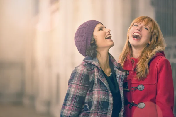 Young women laughing together