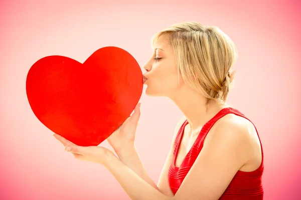 Romantic young beautiful woman kiss love red heart on pink for valentine day