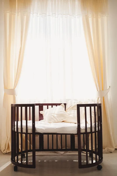 Elegant expensive bed for newborn baby. Luxury decorations of apartments