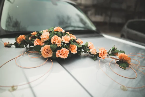 Pretty good wedding bouquet of various flowers on car