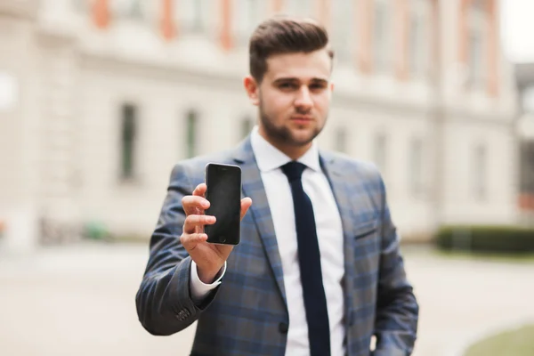 Mobile smart  phone in the hands of a businessman