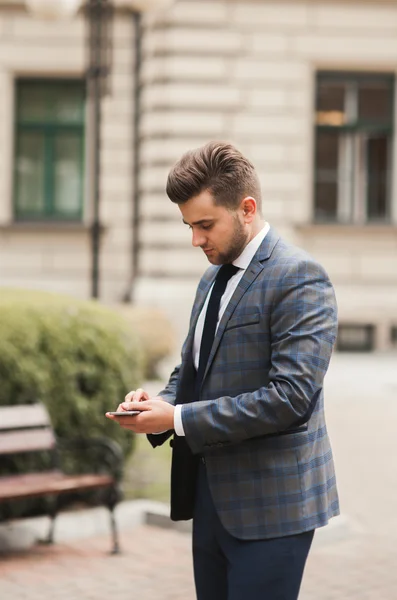 Mobile smart  phone in the hands of a businessman