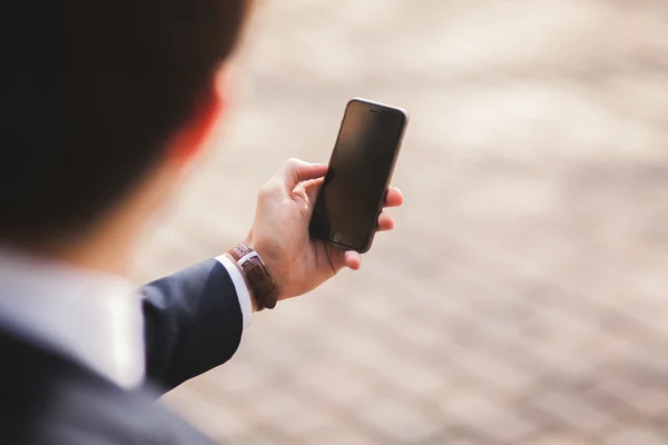 Mobile smart  phone in the hands of a businessman