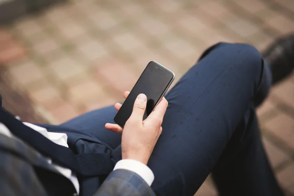 Mobile smart  phone in the hands of a businessman