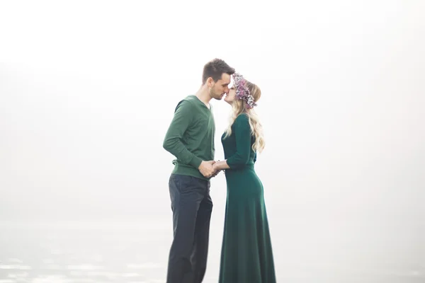 Lovely couple kissing and hugging on a sea dock