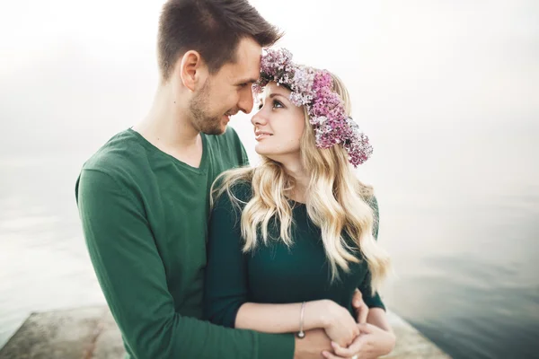 Lovely couple kissing and hugging on a sea dock