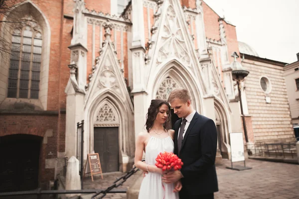 Wedding couple, bride and groom near a church in Krakow