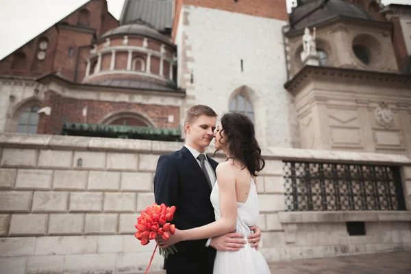 Wedding couple, bride and groom walking near a church in Krakow