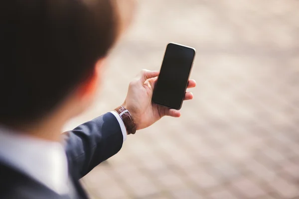 Mobile smart  phone in the hands of a businessman