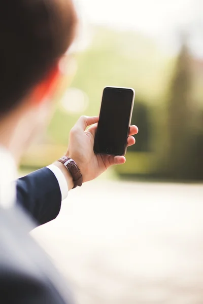 Mobile smart  phone in the hands of a businessman