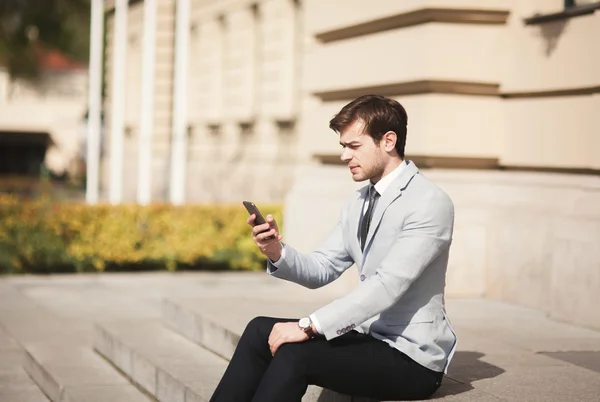 Mobile smart  phone in the hands of a businessman