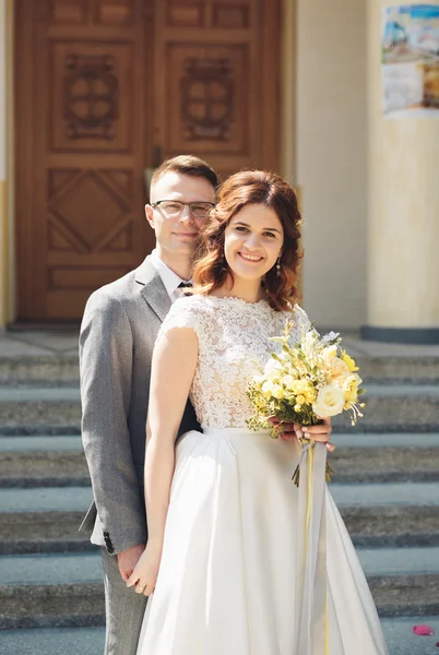 Bride and groom on the background of beautiful church.  old building. Arch. Wedding