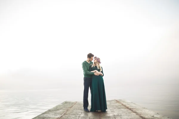 Lovely couple kissing and hugging on a sea dock