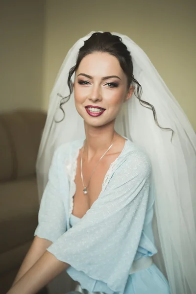 Luxury bride in white dress posing while preparing for the wedding ceremony