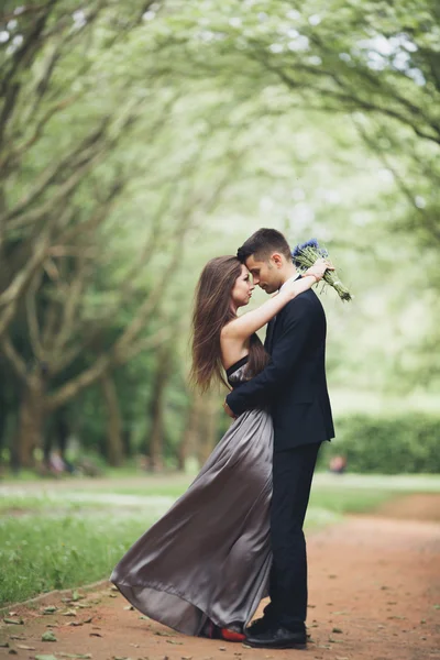 Young beautiful couple, girl with perfect dress posing in park