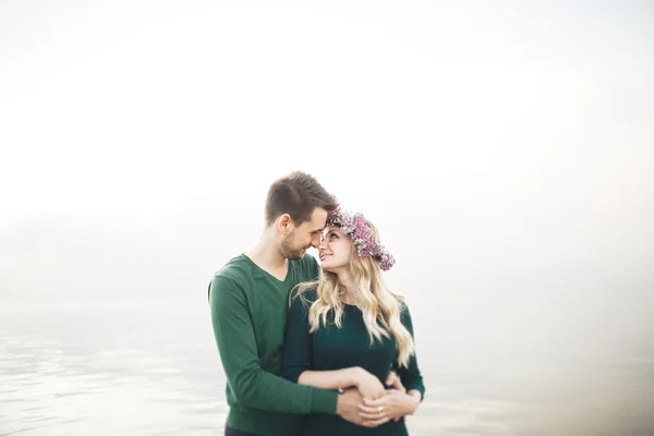 Lovely couple kissing and hugging on a sea dock