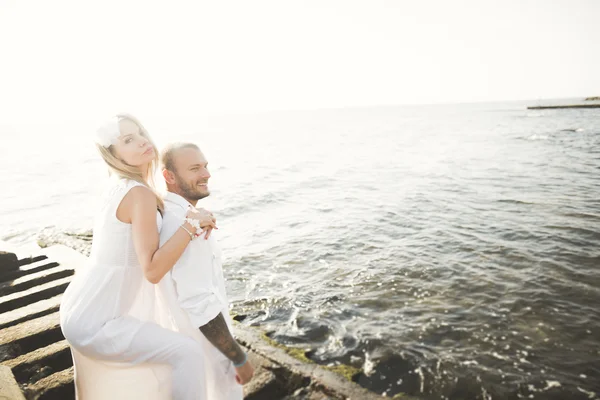 Happy romantic fashion couple in love have fun on beautiful sea at summer day
