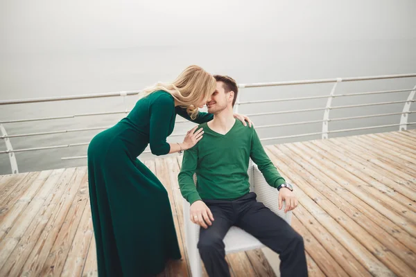 Happy couple on the pier, young family in love spending honeymoon vacation luxury islands