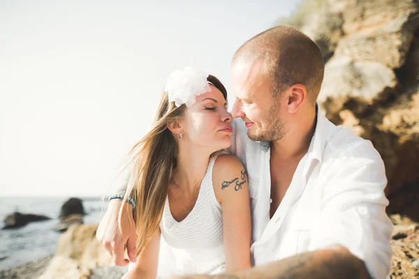Fashion model couple with tattoo posing outside nea sea