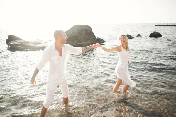 Fashion model couple with tattoo posing outside nea sea