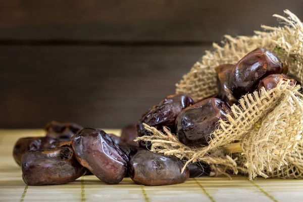 Dates on wooden background