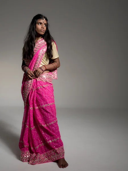 Beautiful young indian woman wearing traditional sari, tikka and