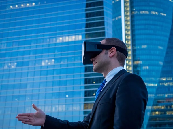 Businessman using virtual reality glasses for a meeting in cyber