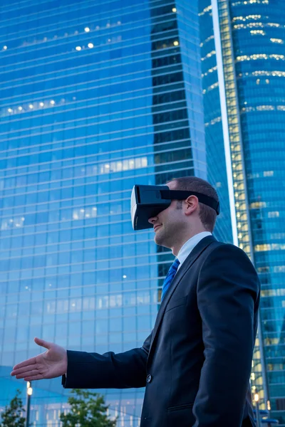 Businessman using virtual reality glasses for a meeting in cyber
