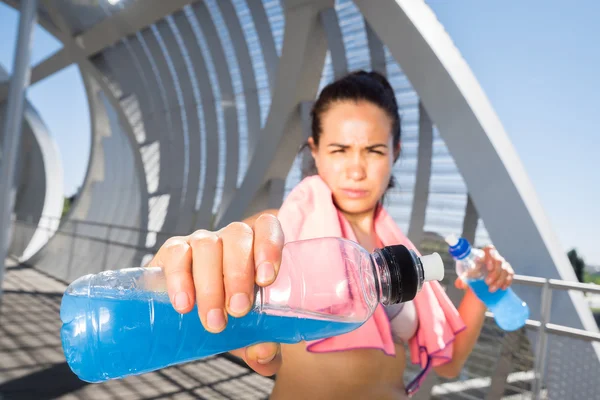 Female runner with energetic drinks for hydration