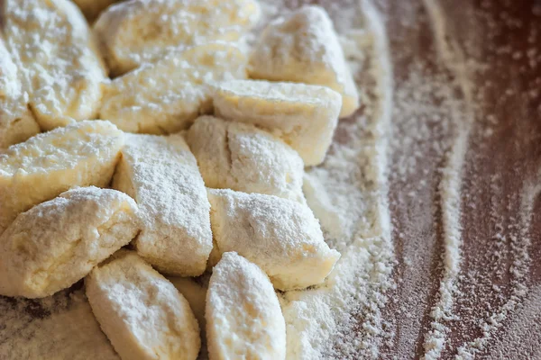 Ukrainian traditional lazy dumplings with cottage cheese. Belarusian and Ukrainian Cuisine. Process of making homemade dumplings on a floured board.,delicious lunch.