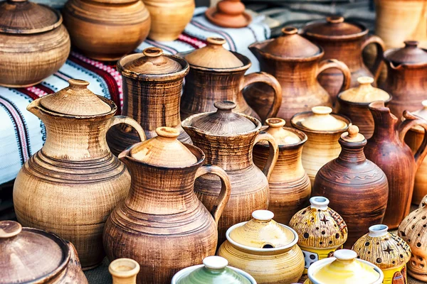 Group of traditional handmade pottery for sale at the market. Ukrainian handmade earthenware utensil. Souvenirs From Ukraine in ethnic style.