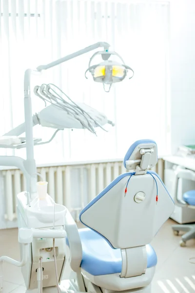 Vertical view of a dentist room with blue seat