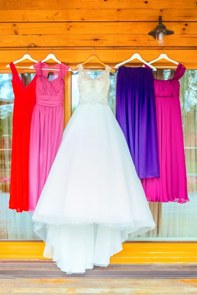 The perfect wedding woman dresses hanging outside of wooden house