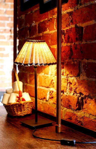 Reading lamps in front of a red brick wall