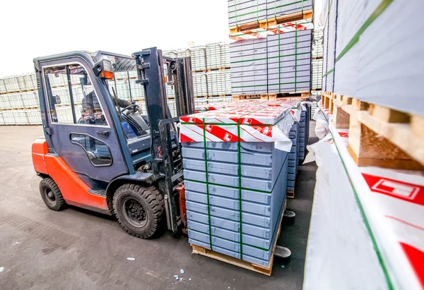 Auto loader with concrete blocks outside factory