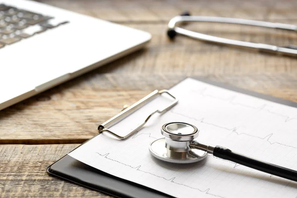 Doctor workplace with a stethoscope at wooden table