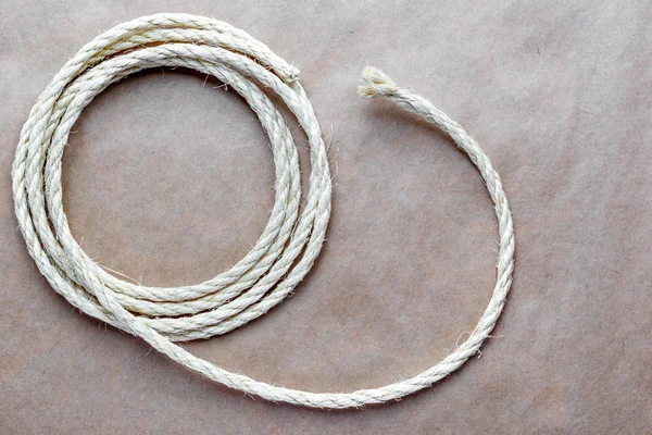 Rope coiled at kraft paper on the background