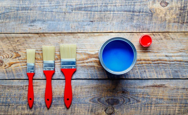 Preparation for painting wooden floor at home with blue paint